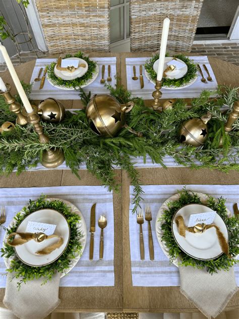 This Simple Christmas Tablescape With Gold Bells And Greenery Is