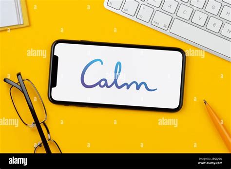 A Smartphone Showing The Calm App Logo Rests On A Yellow Background