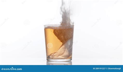 Pink Wine Being Poured Into Glass Against White Background Stock Image