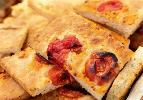 Premium Photo Freshly Baked Homemade Apulian Focaccia With Tomatoes Cut In Slices Close Up