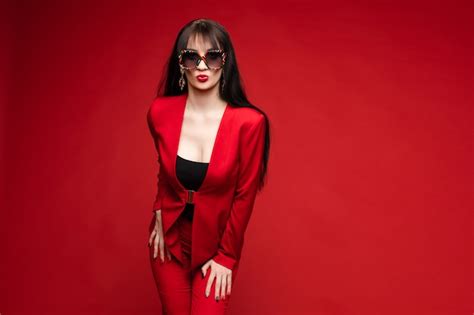 Premium Photo Side View Of Glamorous Brunette Posing In Red Suit