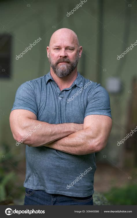 Macho Tough Guy Posing With Arms Crossed Man Is Bald With A Ful Stock