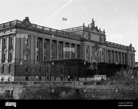 A monochrome shot of the Swedish parliament building architecture with flag Stock Photo - Alamy