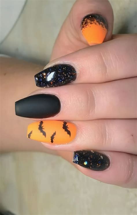 Picture Of Orange And Black Glitter Nails With Bats For A Bold