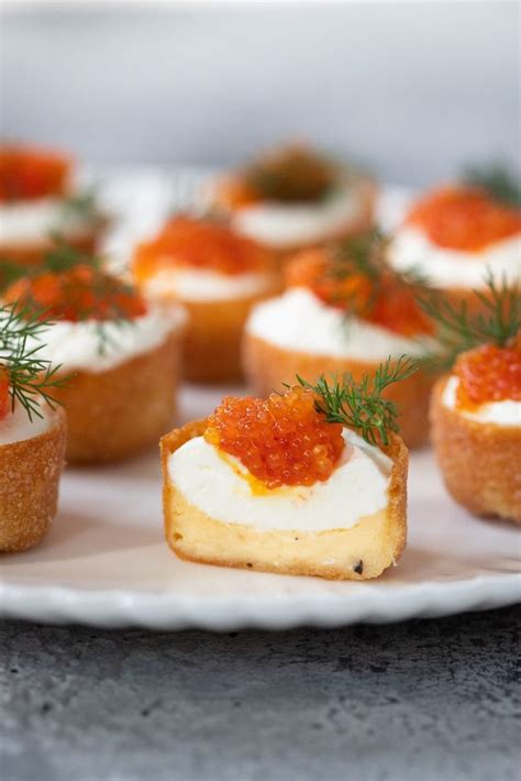 Small Appetizers Are Arranged On A Plate With Garnishes And Sprinkles