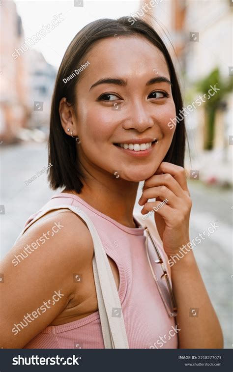 Brunette Asian Woman Smiling Looking Aside Stock Photo 2218277073