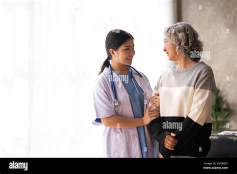 Young Caregiver Helping Senior Woman Walking Nurse Assisting Her Old