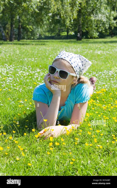 Little Girl Lying On Grass Stock Photo Alamy