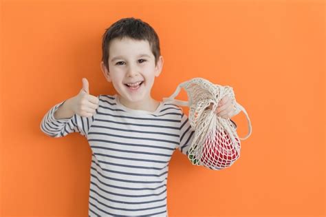 Premium Photo Child With Eco Bag With Vegetables