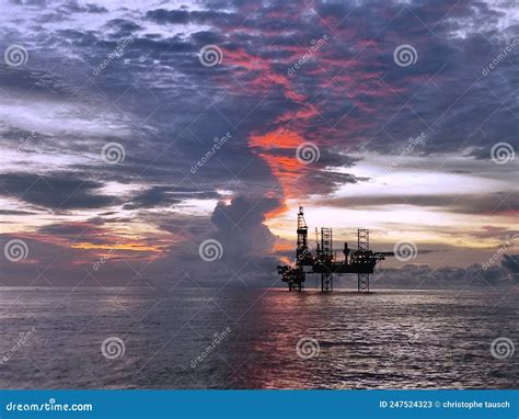 Offshore Oil Platform In The Middle Of The Sea At Sunset Time Natural