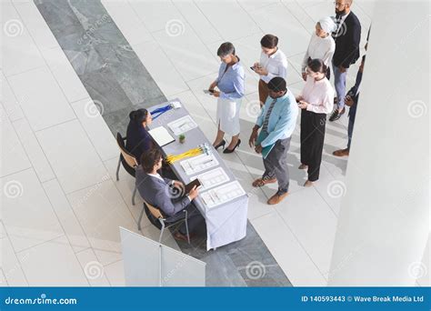 High Angle View Of Business People Checking In At Conference