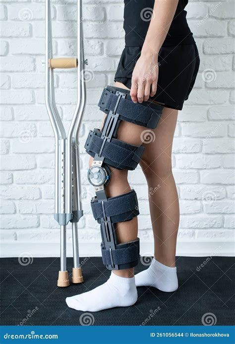 Female Wearing Knee Orthosis Or Knee Support Brace After Surgery On Leg