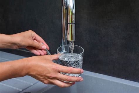 Premium Photo A Woman39s Hand Pours Water Into A Glass