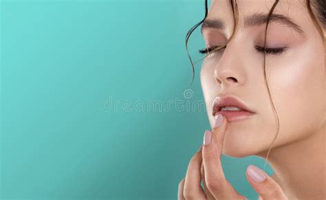 Beauty Smiling Model With Natural Nude Make Up And Long Eyelashes Holding Lipstick Stock Photo