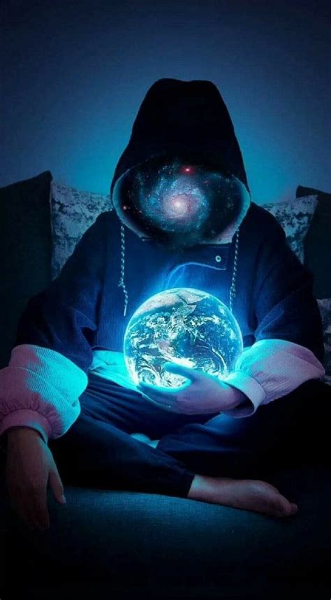 A Person Sitting On A Couch Holding A Glowing Globe