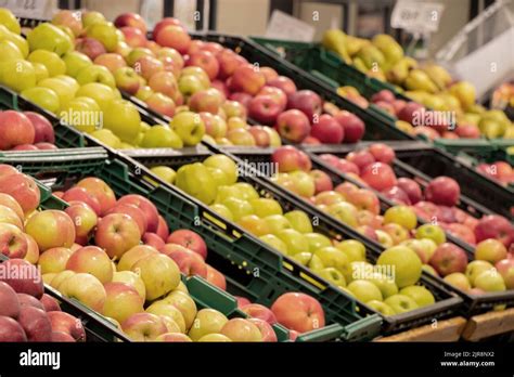 Apples In A Supermarket On Showcases In Boxes Fruits In A Store For