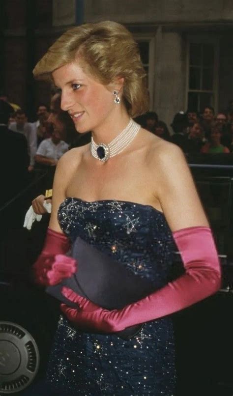 A Woman In A Blue Dress And Pink Gloves