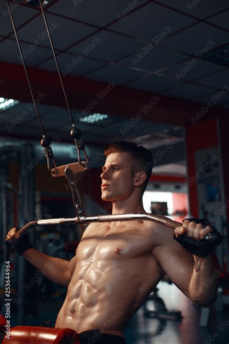 Muscular Model Young Man Exercising In Gym Portrait Of Sporty Strong