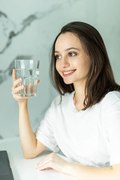 Free Photo Beautiful Young Pretty Woman Holds A Glass With Water On