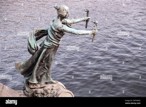 Bronze statue situated on a bridge of Moldova river in summer sunset ...
