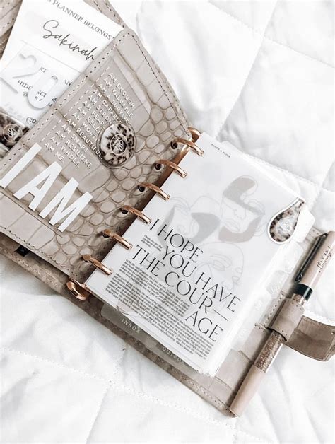 An Open Planner Book Sitting On Top Of A Bed