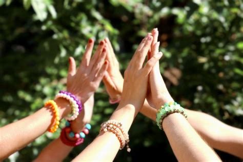 People Putting Hands Together As Symbol Of Unity On White Background