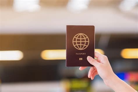 Premium Photo Close Up Of Hand Holding Passport In Airport