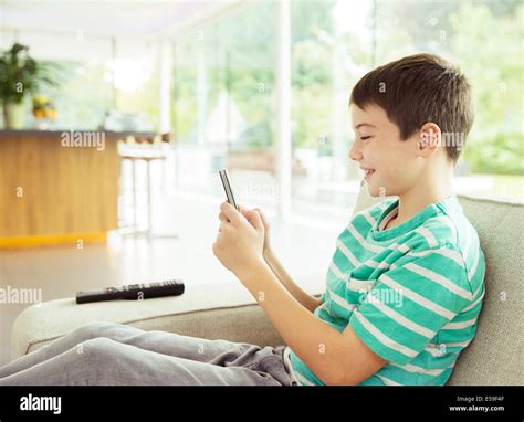 Boy Using Cell Phone On Sofa Stock Photo Royalty Free Image 72124207