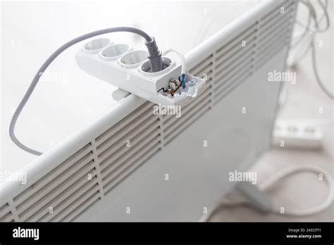 Electric Heater Plug Inserted Into Extension Cord White Radiator For