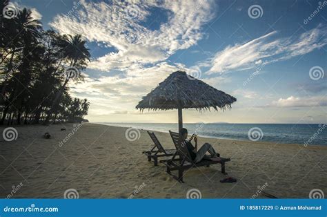 Deckchairs Under The Thatched Roof On A Beach A Tourist Destination In