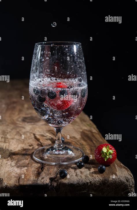 Glass Of Sparkling Water With Fresh Strawberries And Bilberries Water