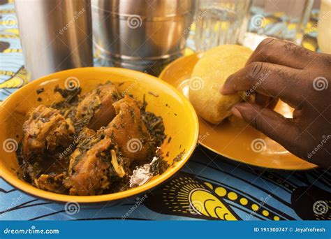 Eating A Yummy Meal Of Nigerian Garri Or Eba And Vegetable Soup Stock