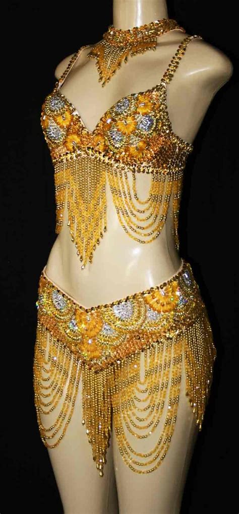 A Mannequin With Gold Beads And Chains On It S Chest In Front Of A