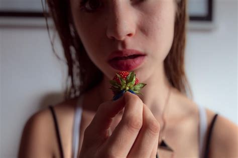 Premium Photo Close Up Of Woman Holding Strawberry