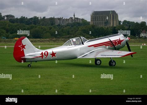 Russian Yakovlev Yak 52 Trainer Plane Taxiing Down The Grass Runway At