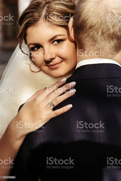 Happy Gorgeous Blonde Bride And Stylish Handsome Groom Hugging With