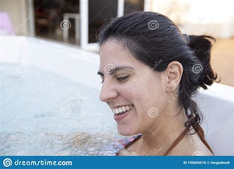 Beautiful Woman Smiling Wearing Bikini In A Hydromassage Bath Stock