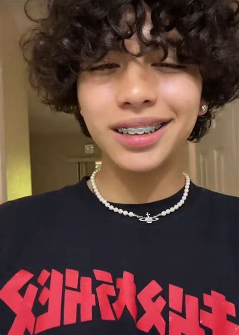 A Woman With Curly Hair Wearing A Black Shirt