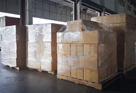 Interior Of Storage Warehouse Stacked Of Package Boxes Wrapped Plastic