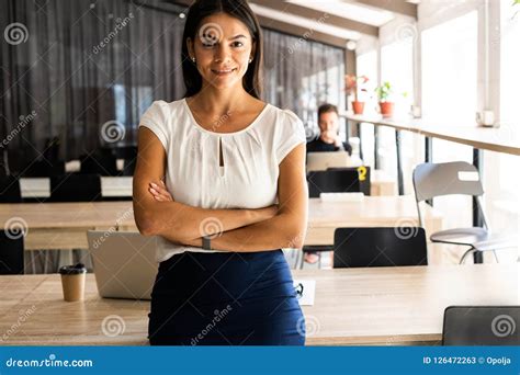 Smiling Professional Businesswoman In Casual With Arms Crossed