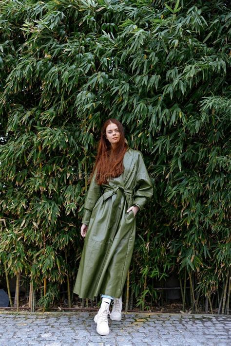 Woman Influencer In Stylish Trendy Clothes Poses Full Length Against A