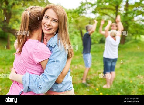 Two Women As Friends Hug Each Other Happily When They Meet Again In