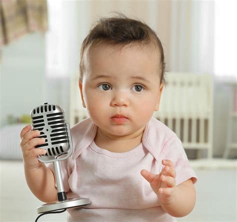 Premium Photo | Cute little baby with microphone at home