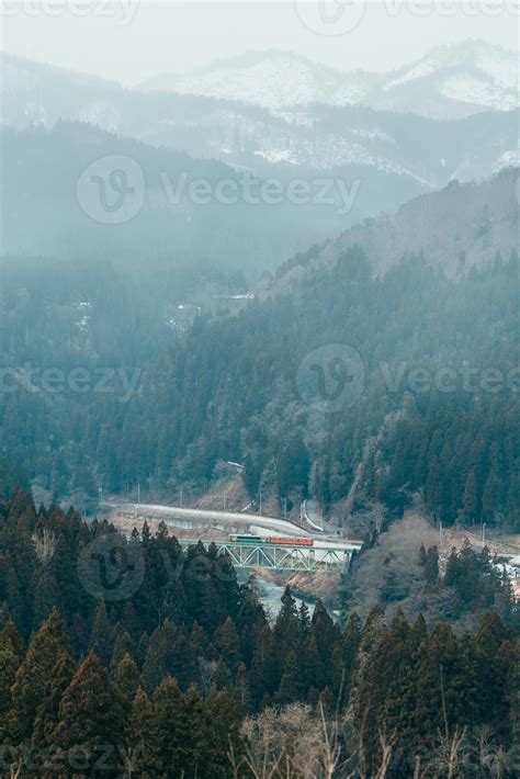 Panoramic View Of Japan Local Train With Tadami River And Bridge