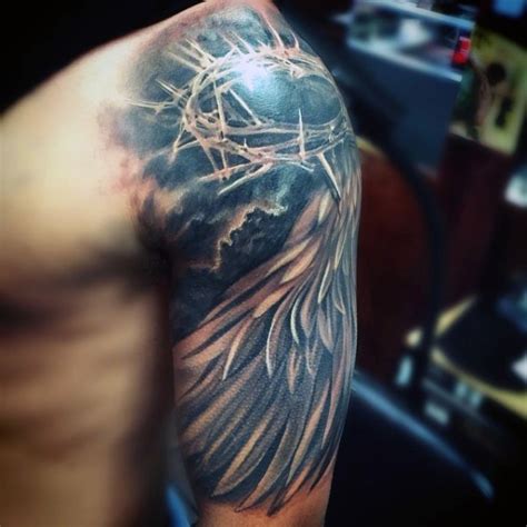 Sharp Crown Of Thorns And Feather Wing Religious Shoulder Tattoo In