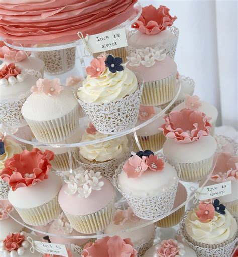 There Are Many Cupcakes On This Tiered Cake Stand That Is Decorated