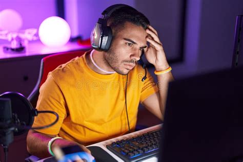 Young Hispanic Man Streamer Stressed Using Computer At Gaming Room