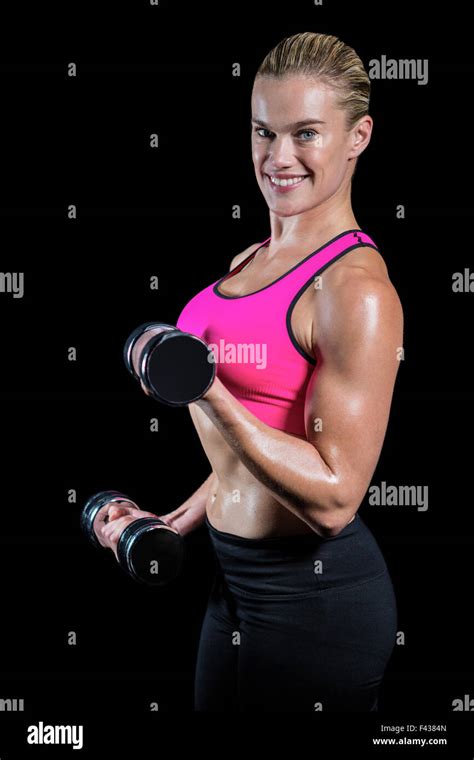 Muscular Woman Lifting Heavy Dumbbells Stock Photo Alamy