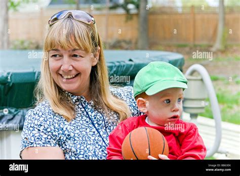 Woman Holding Baby With Basketball Stock Photo Alamy