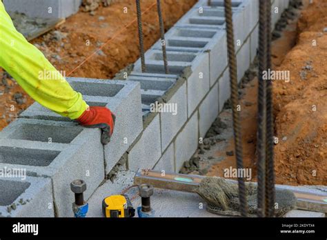 Another Row Of Cement Blocks Is Being Laid Down By Bricklayer